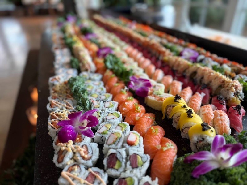 Beautiful party sushi table setup with multiple platters